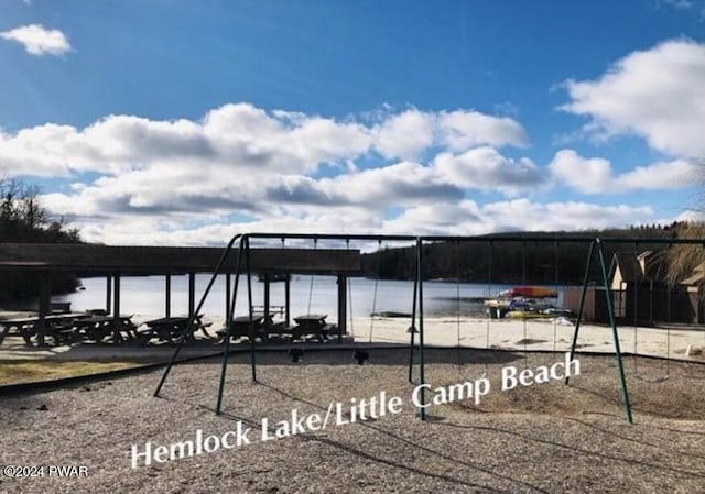 exterior space featuring a water view and a playground