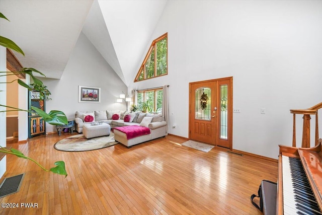 living room with a high ceiling and light hardwood / wood-style floors