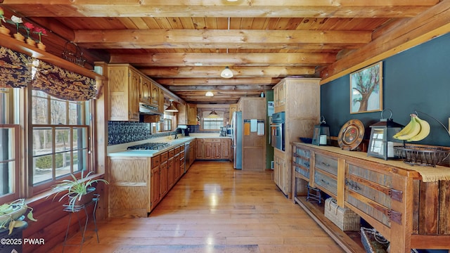 kitchen featuring light hardwood / wood-style flooring, wall oven, beamed ceiling, decorative backsplash, and stainless steel gas stovetop