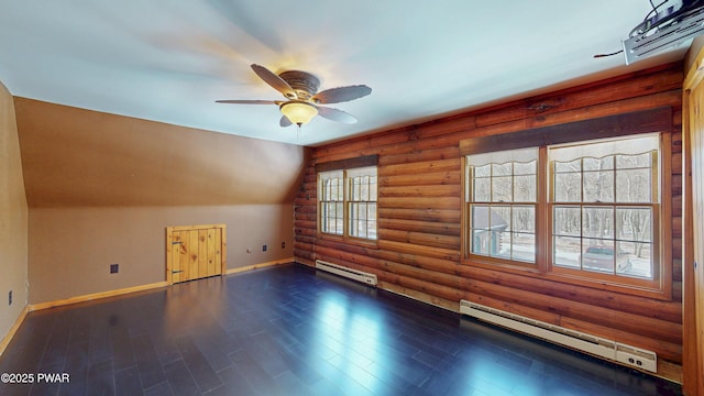 additional living space featuring dark wood-type flooring, log walls, vaulted ceiling, and a baseboard heating unit