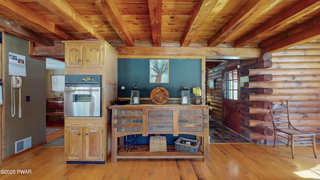 kitchen with log walls, oven, wood ceiling, beam ceiling, and light hardwood / wood-style flooring