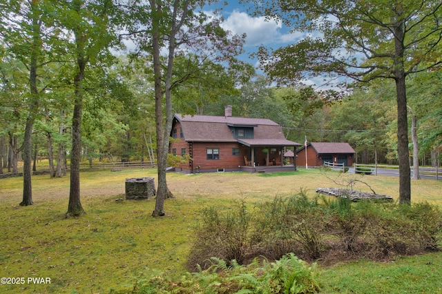 log cabin featuring central air condition unit and a front lawn