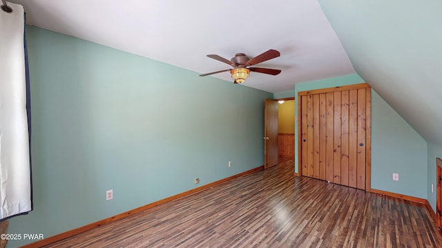 unfurnished bedroom featuring lofted ceiling, dark wood-type flooring, and ceiling fan