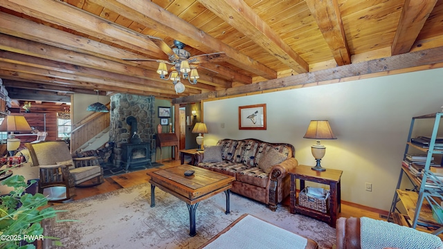 living room featuring wood ceiling, light hardwood / wood-style floors, beamed ceiling, and a wood stove