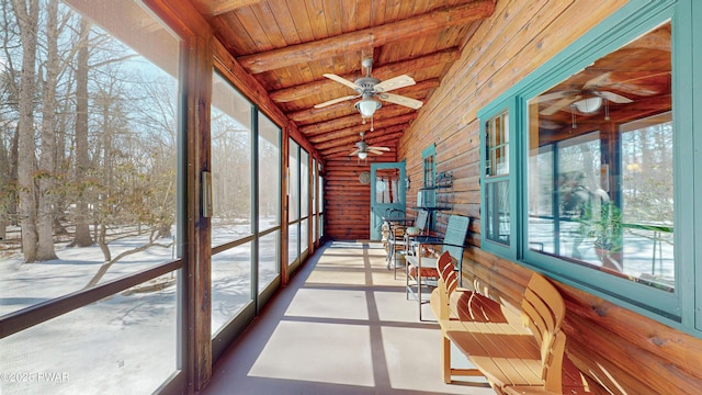 unfurnished sunroom with lofted ceiling with beams, wooden ceiling, and ceiling fan