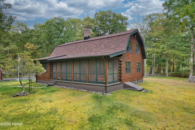 view of side of home featuring a lawn and a sunroom