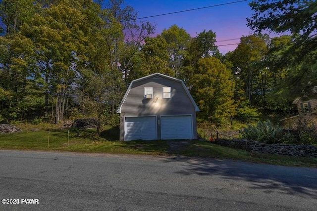 view of garage at dusk