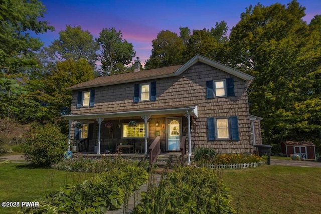 front facade featuring a porch and a yard