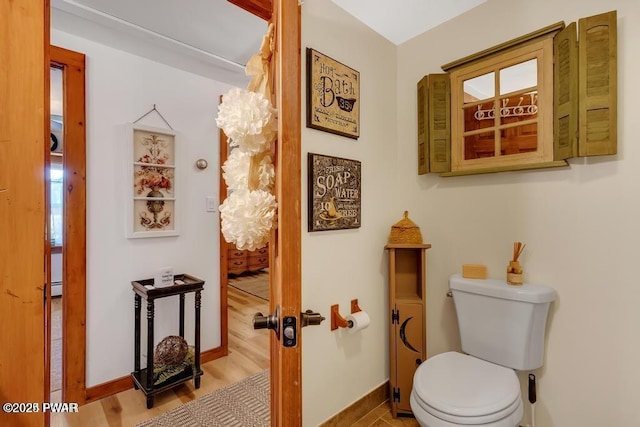 bathroom with hardwood / wood-style flooring and toilet