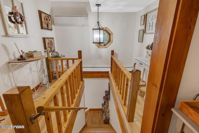 interior space with hardwood / wood-style floors and a wall unit AC