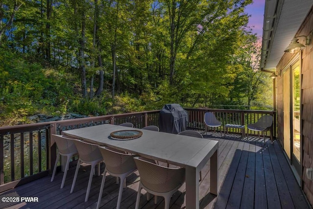 deck at dusk with area for grilling