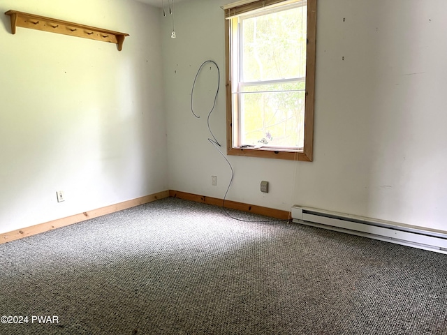 unfurnished room with baseboard heating and carpet flooring