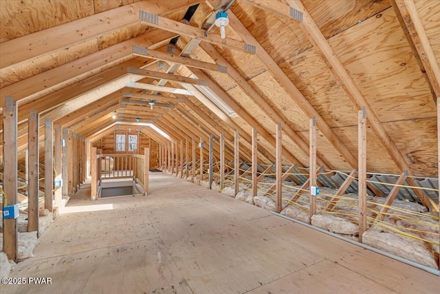 unfinished attic with an upstairs landing