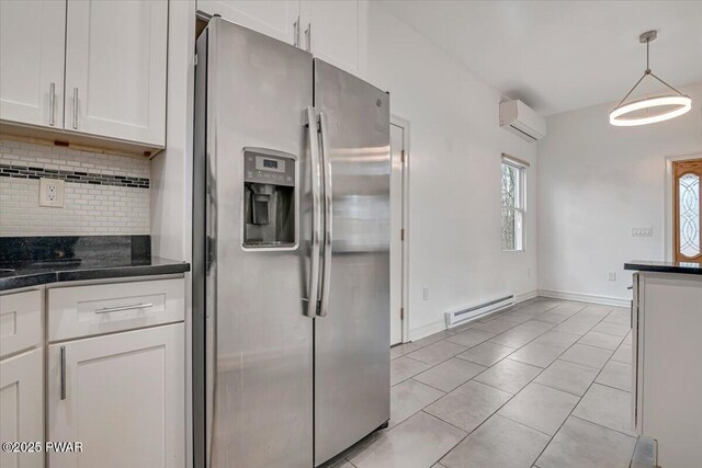 kitchen with stainless steel fridge with ice dispenser, white cabinets, a wall mounted air conditioner, a baseboard heating unit, and backsplash