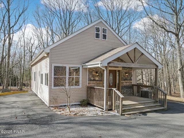 view of front of property with covered porch and stone siding