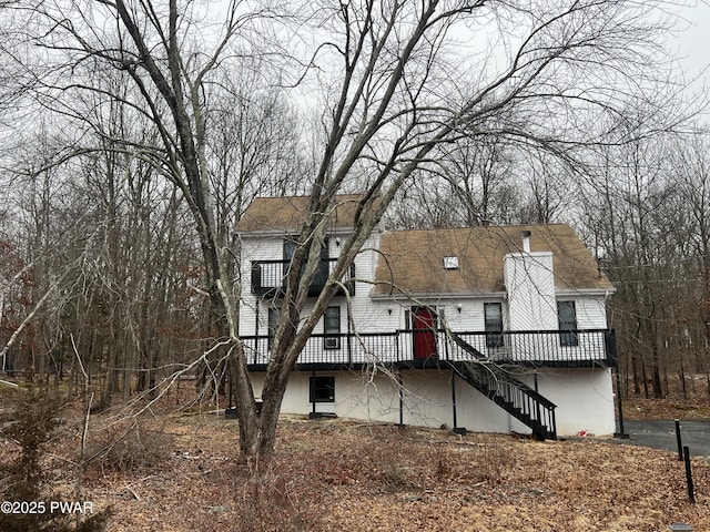 rear view of property featuring a deck