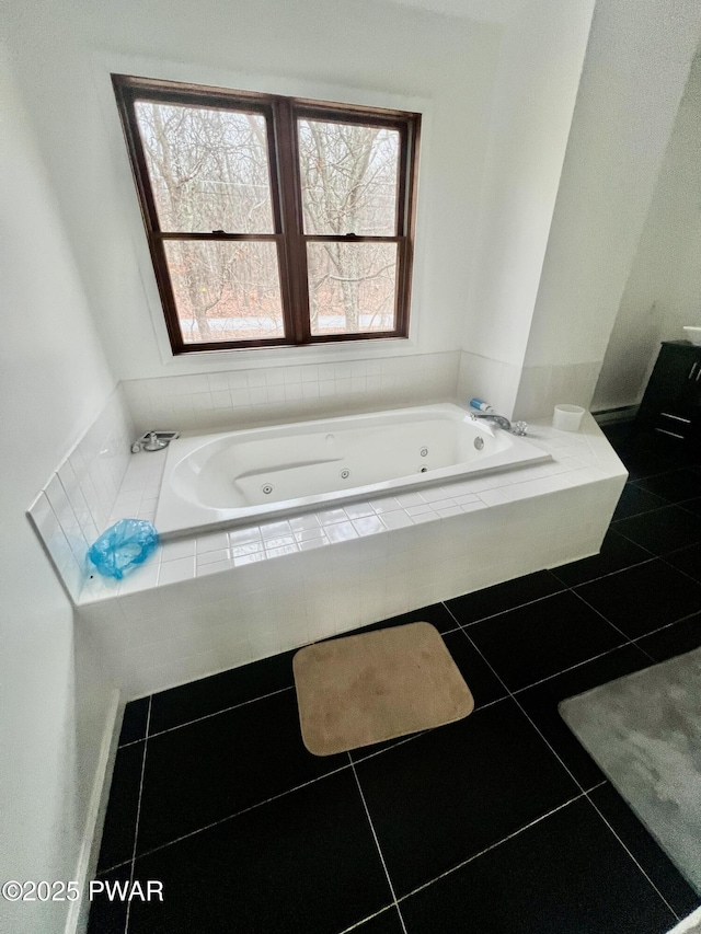 bathroom featuring tiled bath and tile patterned floors