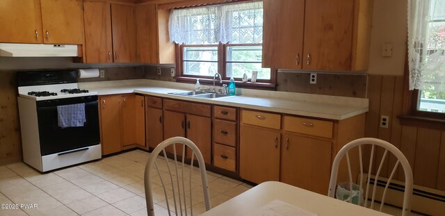 3307 Creamton Dr, Preston Park, PA 18455 - kitchen with gas range, under cabinet range hood, light countertops, and baseboard heating
