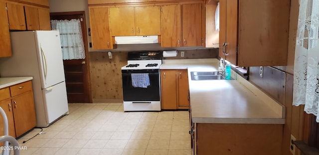 3307 Creamton Dr, Preston Park, PA 18455 - kitchen with range hood, white appliances, brown cabinetry, and light countertops