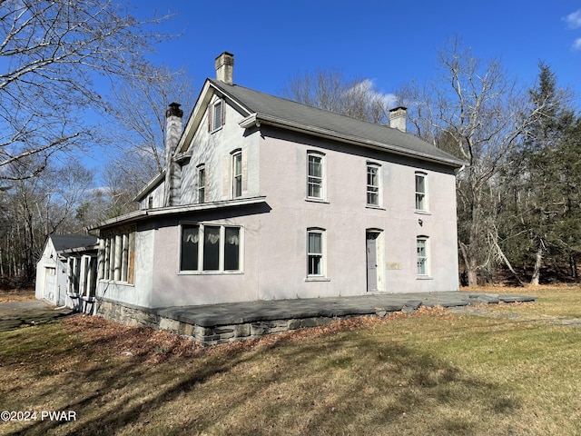 view of side of property with a lawn