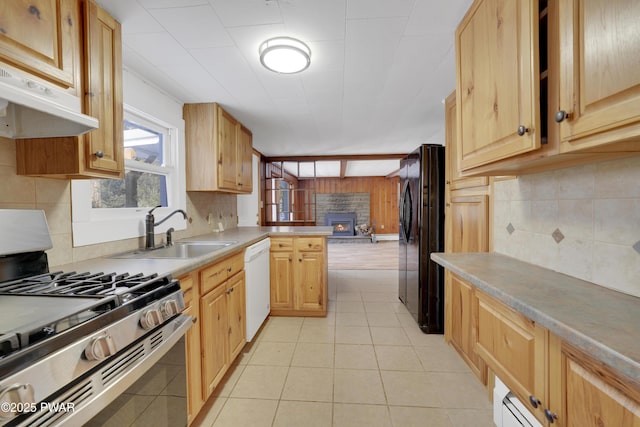 kitchen featuring sink, gas range, black refrigerator, white dishwasher, and kitchen peninsula