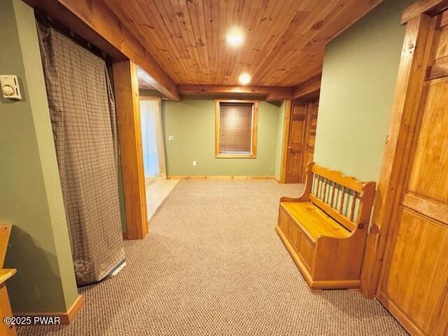 hall with light colored carpet and wooden ceiling