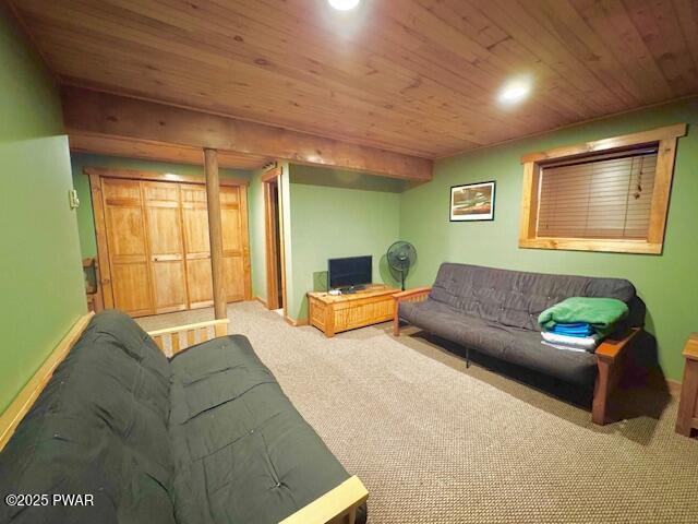 carpeted living room featuring wood ceiling