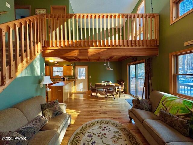 living room with a high ceiling and light wood-type flooring