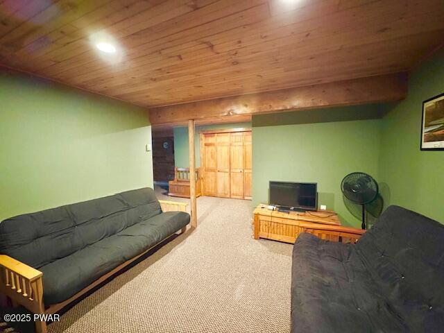 carpeted living room featuring wood ceiling