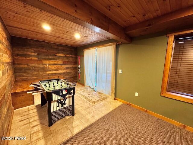 rec room with beam ceiling, light tile patterned floors, and wooden ceiling