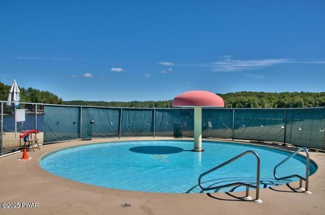 view of swimming pool with basketball court