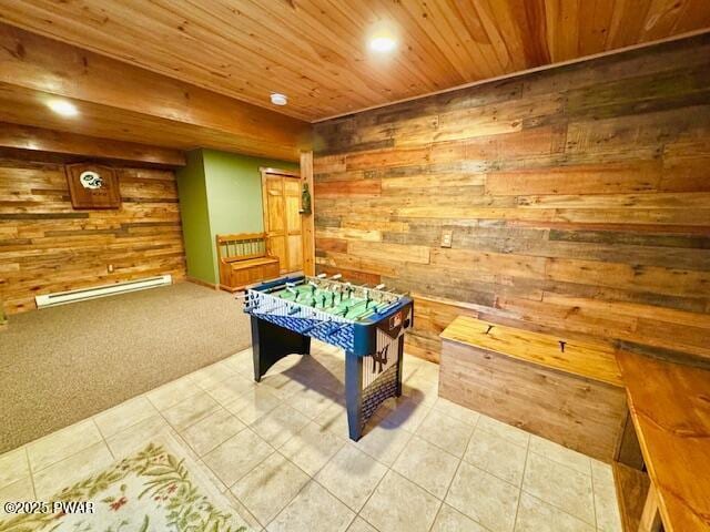 game room with carpet floors, a baseboard heating unit, wooden ceiling, and wooden walls