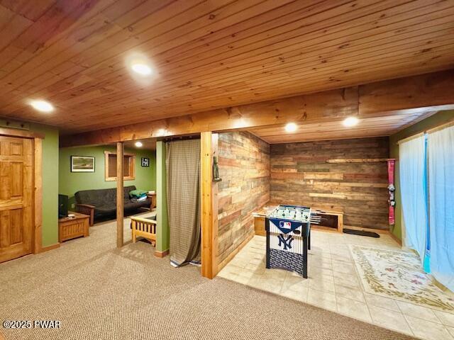 recreation room featuring wood ceiling, tile patterned floors, and wood walls