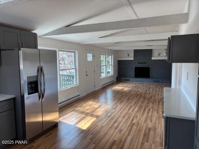 133 Arrowood Dr, Dingmans Ferry, PA 18328 - kitchen featuring baseboard heating, a baseboard radiator, stainless steel fridge, and light wood-type flooring