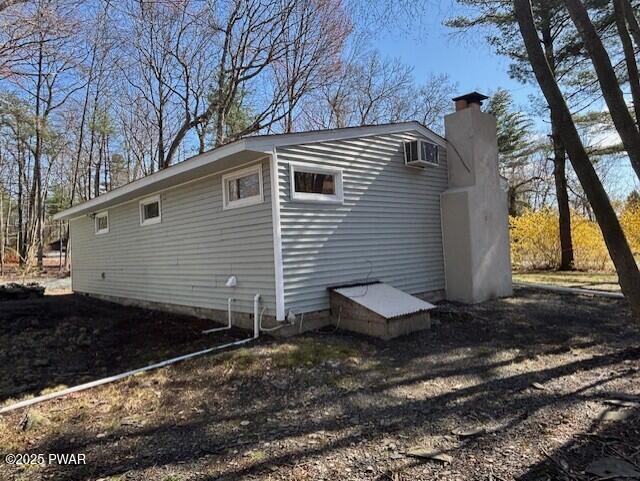 133 Arrowood Dr, Dingmans Ferry, PA 18328 - view of side of home with a chimney