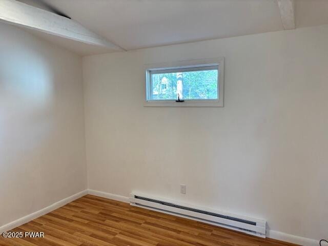 133 Arrowood Dr, Dingmans Ferry, PA 18328 - unfurnished room with a baseboard radiator, wood finished floors, baseboards, and lofted ceiling