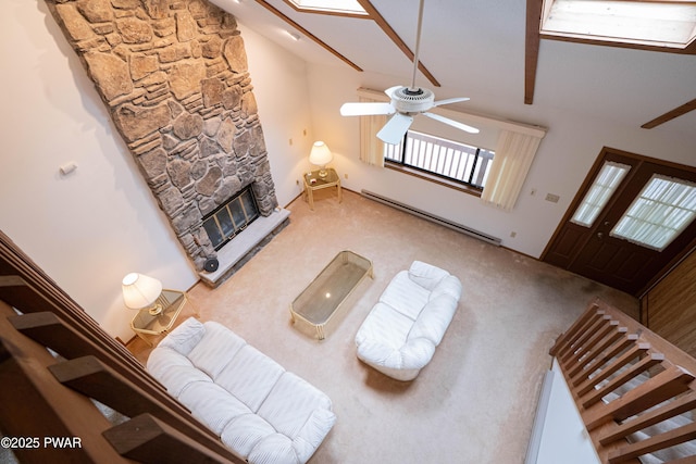 16 Par Ct, Lake Ariel, PA 18436 - carpeted living room featuring a ceiling fan, baseboard heating, a stone fireplace, and lofted ceiling