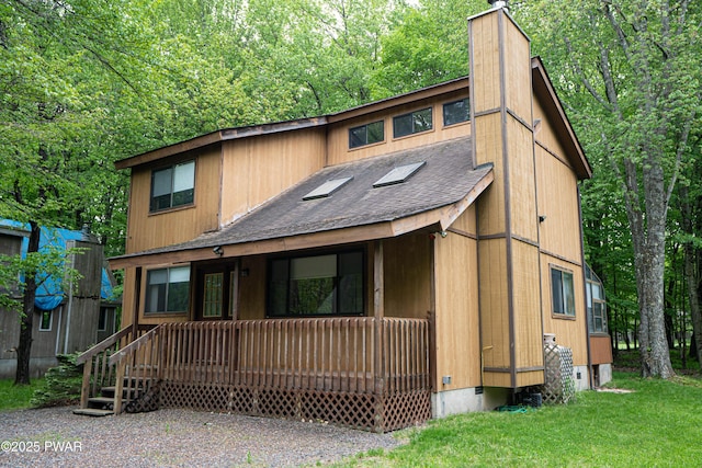 16 Par Ct, Lake Ariel, PA 18436 - chalet / cabin with a porch, a shingled roof, a chimney, and a front lawn