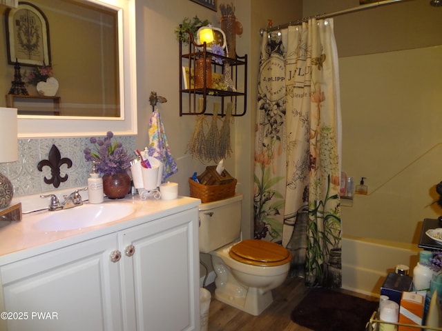 full bathroom with toilet, vanity, tasteful backsplash, hardwood / wood-style floors, and shower / tub combo with curtain