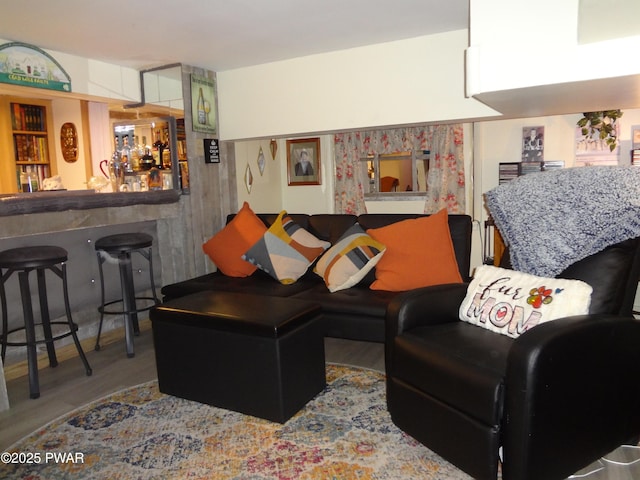 living room featuring indoor bar and hardwood / wood-style floors