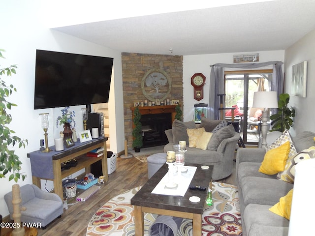 living room featuring wood-type flooring and a fireplace