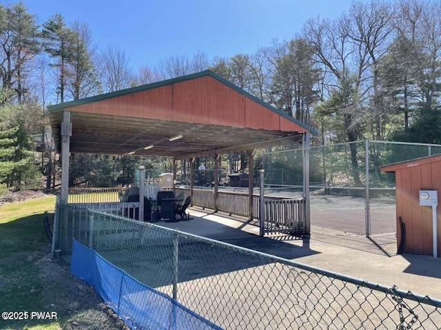 view of community featuring tennis court