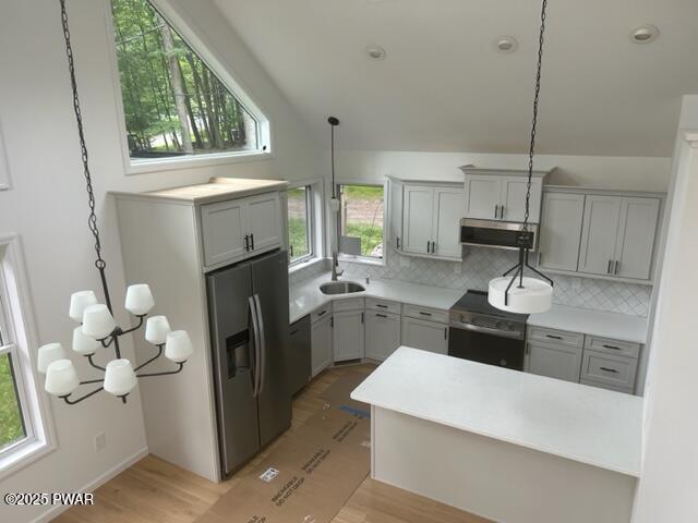 104 Maple Park Dr, Shohola, PA 18458 - kitchen with range, stainless steel refrigerator with ice dispenser, range hood, decorative backsplash, and gray cabinets