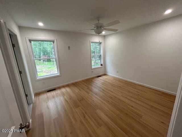 104 Maple Park Dr, Shohola, PA 18458 - unfurnished bedroom with multiple windows, light wood finished floors, recessed lighting, and ceiling fan