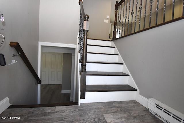 stairway with a baseboard radiator