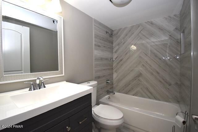 full bathroom with vanity, toilet, and tiled shower / bath