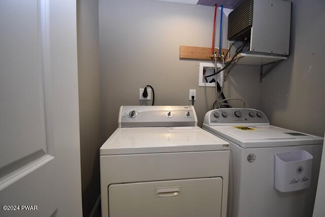 washroom with independent washer and dryer