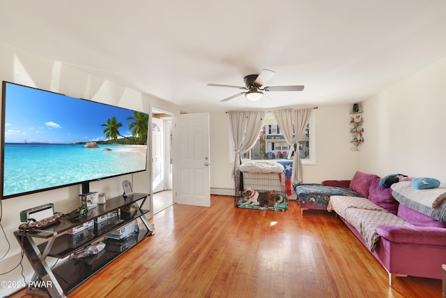 living room with hardwood / wood-style flooring, ceiling fan, and baseboard heating