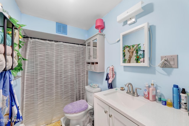 bathroom featuring vanity, a shower with shower curtain, and toilet