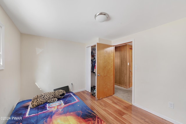 bedroom featuring wood-type flooring and a closet